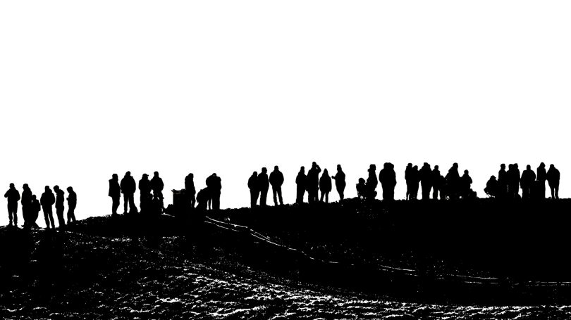 Best view of the race! Silhouetted people on top of a hill, by Denis Taylor